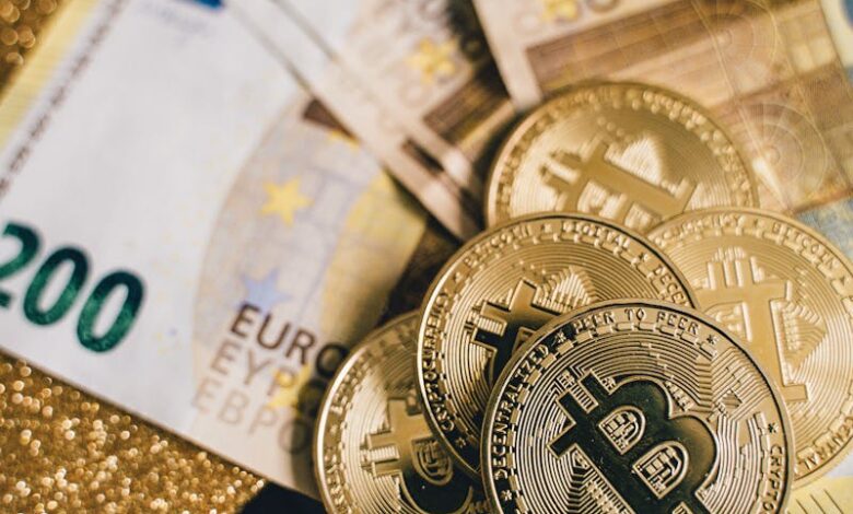 Close-up of Euro banknotes with Bitcoin coins on a glittery background symbolizing modern currency and investment.