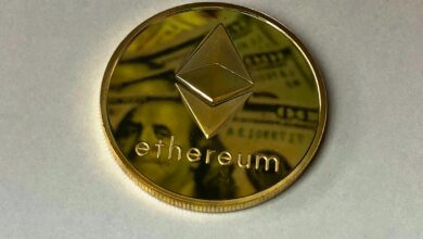 Close-up of a shining Ethereum coin reflecting a dollar bill, symbolizing digital currency and wealth.