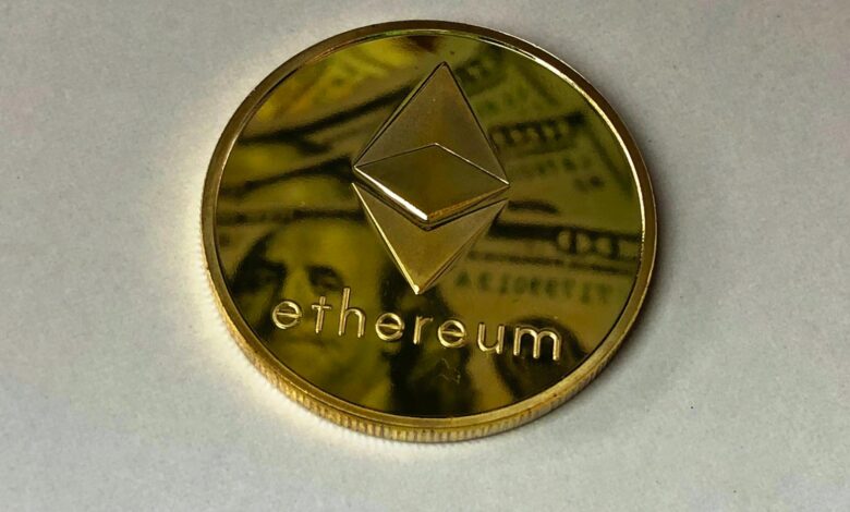 Close-up of a shining Ethereum coin reflecting a dollar bill, symbolizing digital currency and wealth.