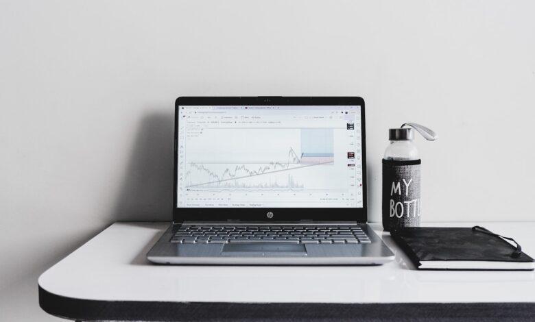 a laptop computer sitting on top of a white desk