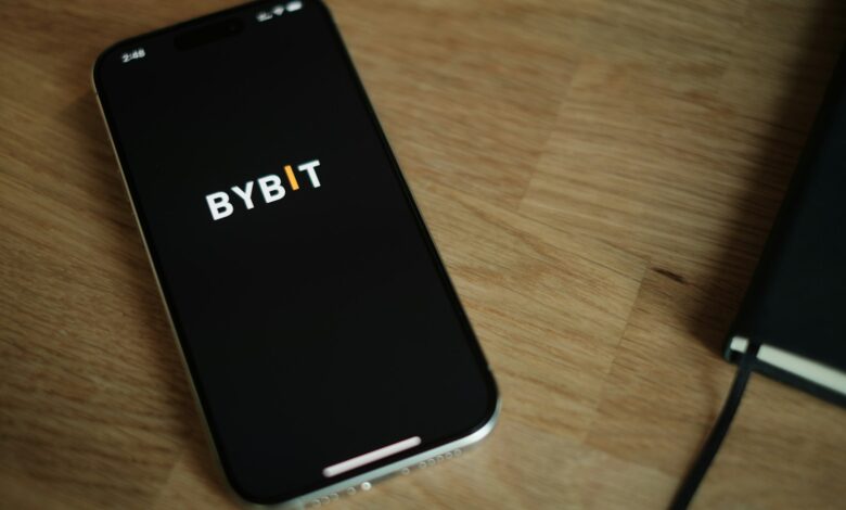 A cell phone sitting on top of a wooden table