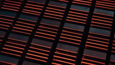 a close up of a metal grate with red lights