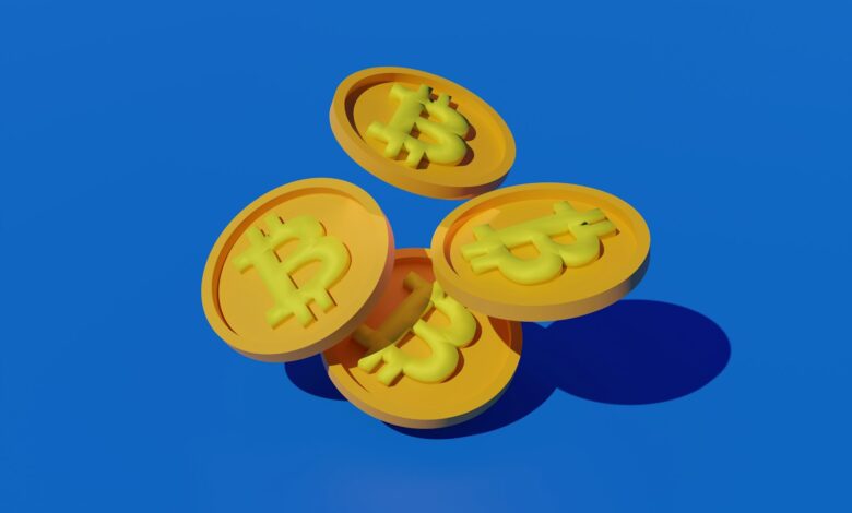 three gold bitcoins sitting on top of each other