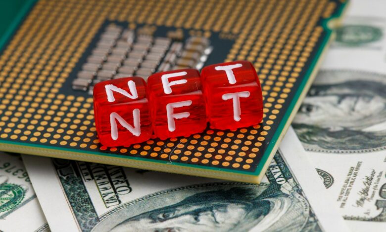 a close up of a small red block on top of a pile of money